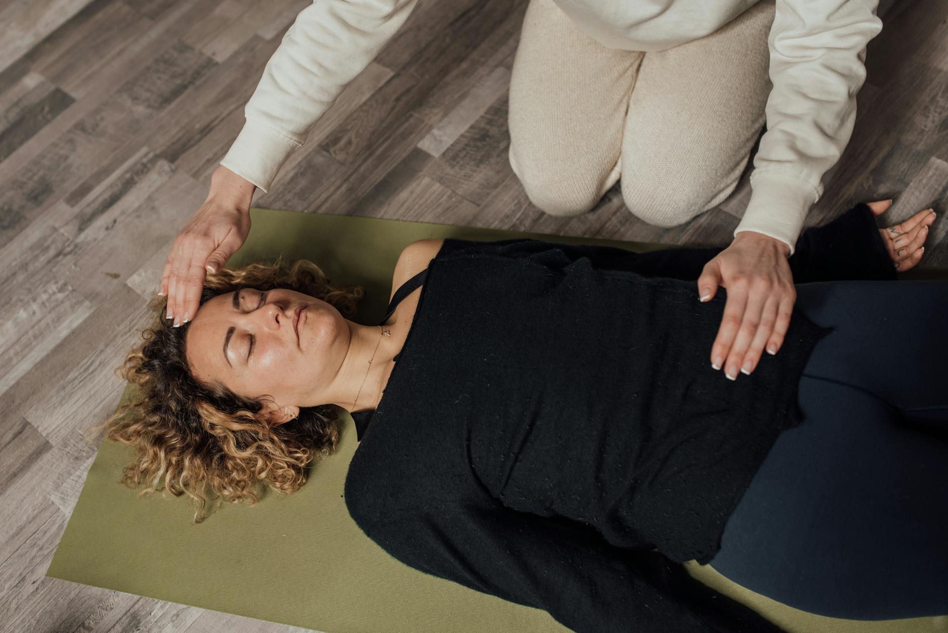 Kobieta z zamkniętymi oczami medytuje, skupiając się na wewnętrznym spokoju